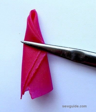 Fold the ribbon to form the shape of a rose bud