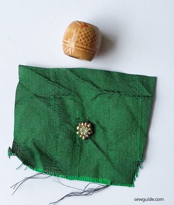 wooden bead and fabric piece