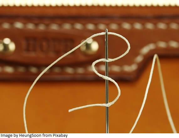 Knotting the thread for hand sewing leather