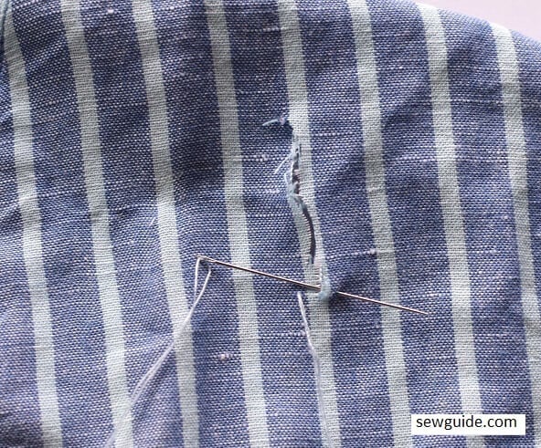use a needle and matching thread to stitch and repair small tears on clothes