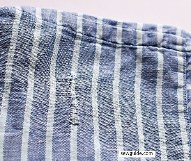 how to repair cuts on clothes with hand sewing needle and thread and small stitches across the cut