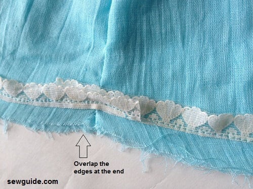 Attach fabric trim to the hem of the skirt