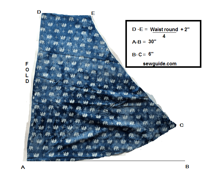 Skirt pattern for the umbrella dress marked on a folded fabric.